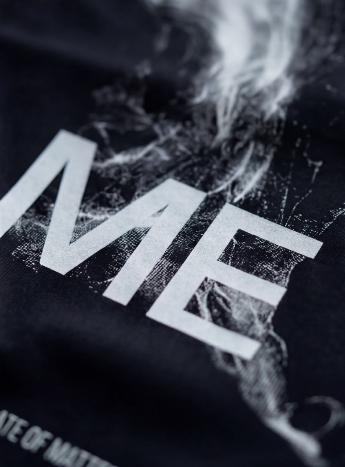 LOSE ME tee — extreme close-up of the dissolving figure print, white on black